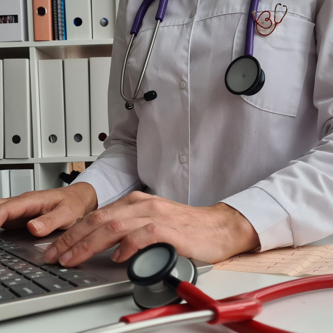 Medical student typing on laptop.